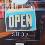 An OPEN sign hanging in a store window.