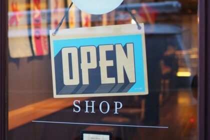 An OPEN sign hanging in a store window.