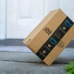 An Amazon Prime package sitting on a front porch step.