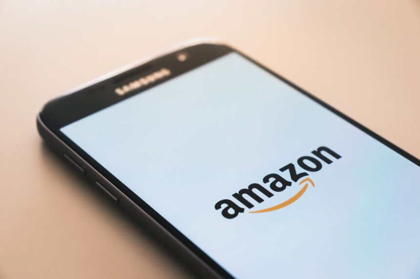 Smartphone displaying the Amazon logo on its screen.