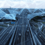 Cars driving on a highway with a digital network overlay representing connected infrastructure.
