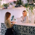 Customer paying for products at a boutique counter with a smiling staff member.