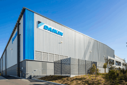 Exterior view of a modern Daikin industrial warehouse building under a clear blue sky.