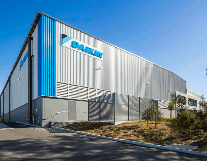 Exterior view of a modern Daikin industrial warehouse building under a clear blue sky.