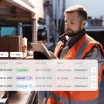 Warehouse worker in a high-visibility vest using a tablet with a digital booking dashboard.
