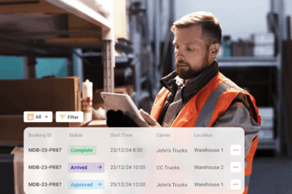 Warehouse worker in a high-visibility vest using a tablet with a digital booking dashboard.