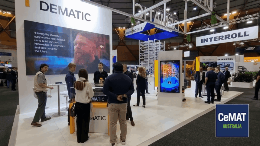 People interacting at a busy Dematic and Interroll trade show booth at CeMAT Australia.