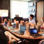 A professional team listens to a presentation in a modern conference room.