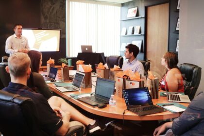 A professional team listens to a presentation in a modern conference room.