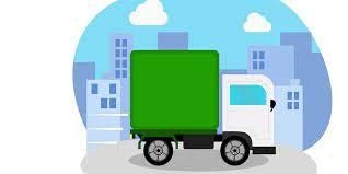 A white delivery truck with a green cargo container driving through a city.