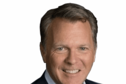 Professional headshot of a middle-aged man in a suit jacket and dress shirt.