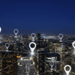 Digital location pin network overlaying an illuminated city skyline at night.