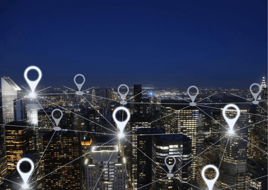Digital location pin network overlaying an illuminated city skyline at night.