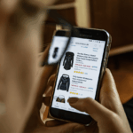 A person views winter jackets on an Amazon mobile webpage through their glasses.