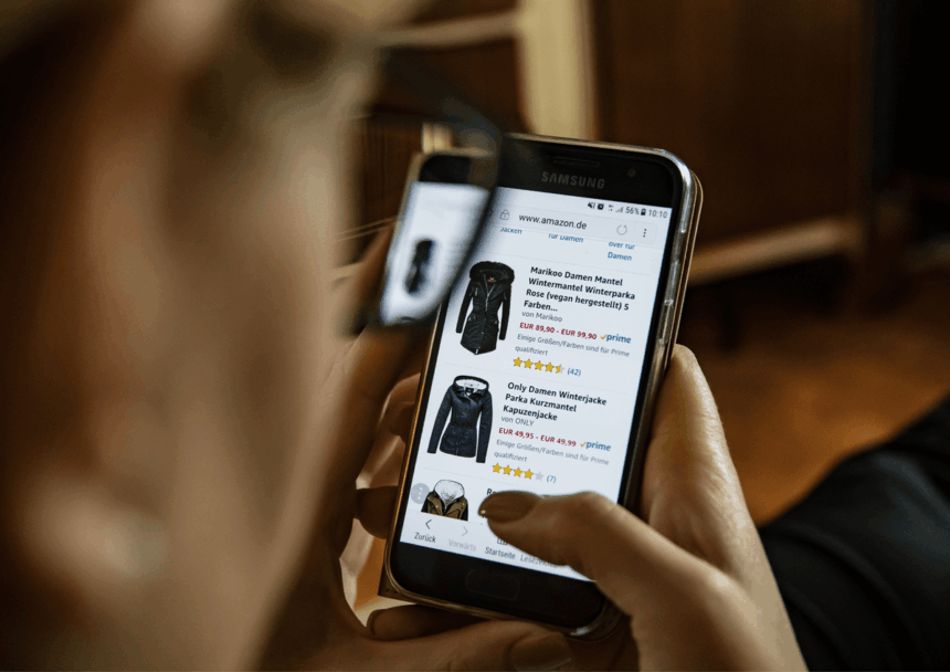 A person views winter jackets on an Amazon mobile webpage through their glasses.