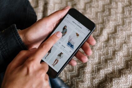 Person browsing a clothing store app on a smartphone.