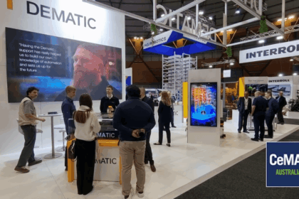 People interacting at the Dematic and Interroll trade show booths at CeMAT Australia.
