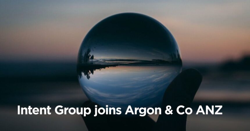 Hand holding a crystal ball reflecting a sunset, with text Intent Group joins Argon & Co ANZ.
