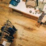 High-angle view of a clothing store with garment racks and a table displaying merchandise.