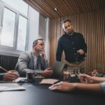 A diverse group of professionals having a collaborative business meeting in a modern office.