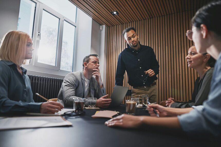 A diverse group of professionals having a collaborative business meeting in a modern office.