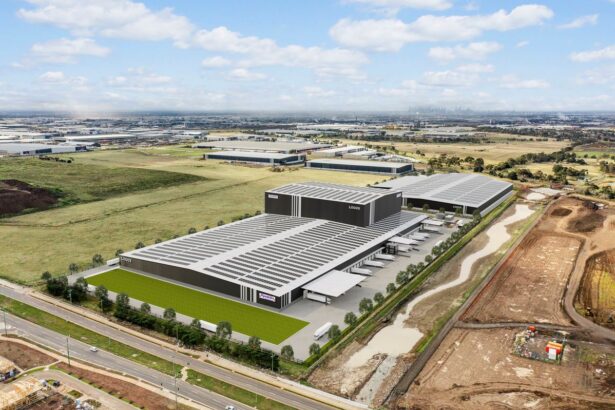 Aerial view of a large modern warehouse facility in an industrial landscape.