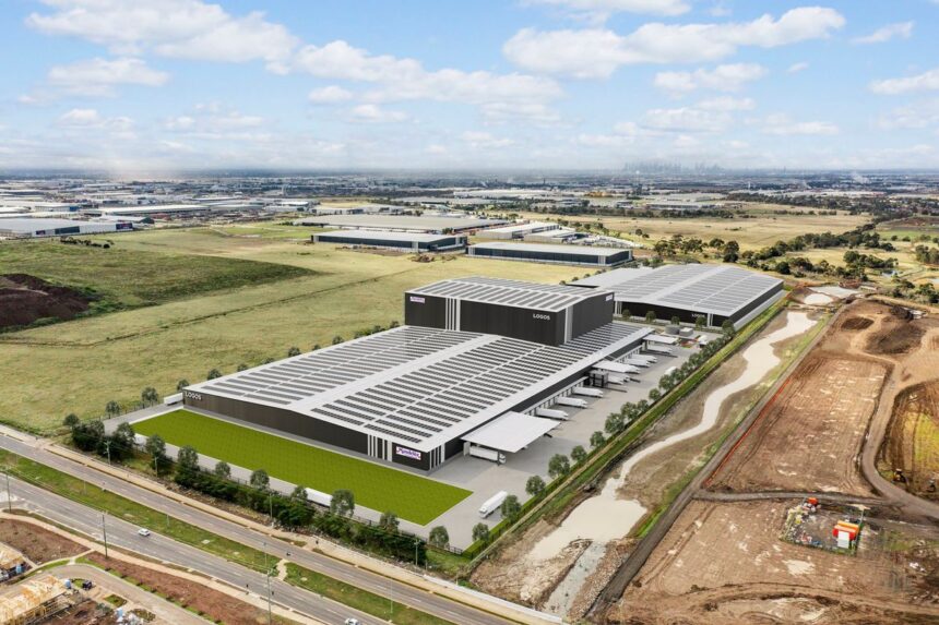 Aerial view of a large modern warehouse facility in an industrial landscape.