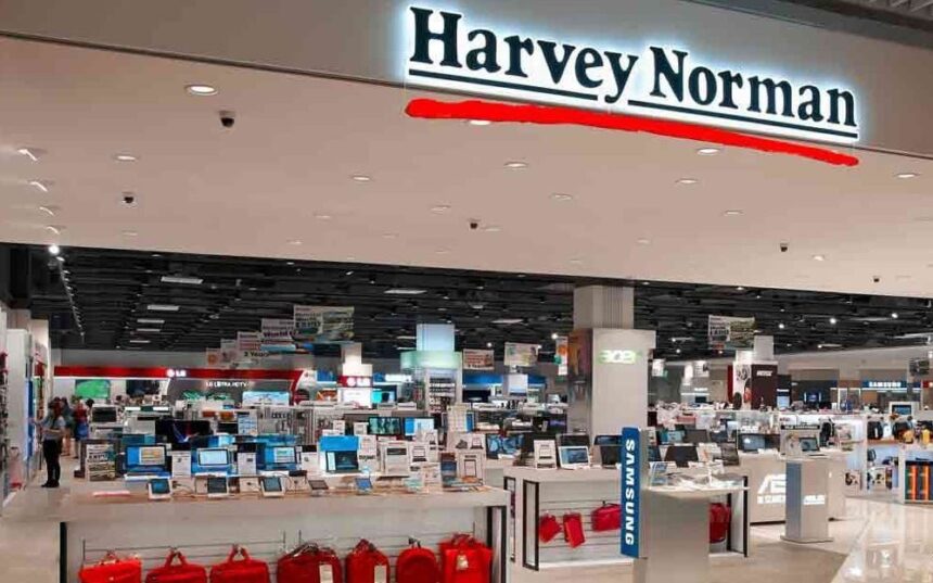 Interior view of a well-lit Harvey Norman electronics store with various displays.