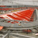 Automated parcel sorting system with conveyor belts in a large distribution warehouse.