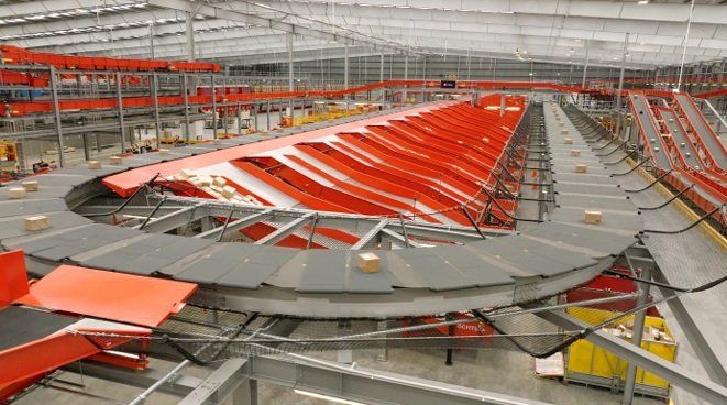 Automated parcel sorting system with conveyor belts in a large distribution warehouse.