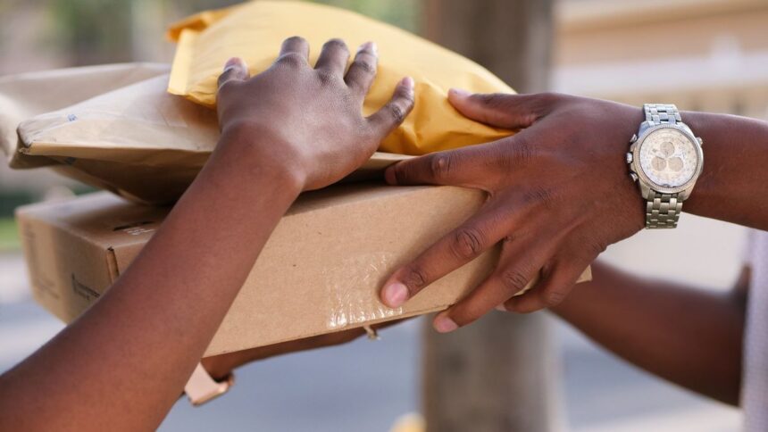 Hands passing parcels and envelopes during a delivery.