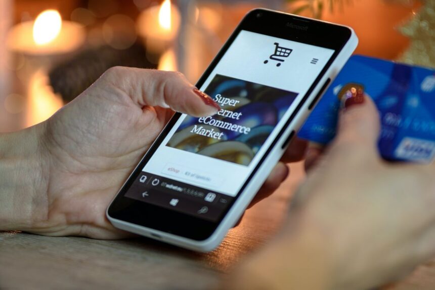 A person using a smartphone to shop online with a credit card.