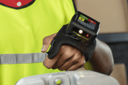 Warehouse worker wearing a hands-free wearable barcode scanner on their hand.