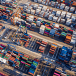 Aerial view of a busy shipping container terminal with rows of colorful containers.