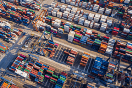 Aerial view of a busy shipping container terminal with rows of colorful containers.
