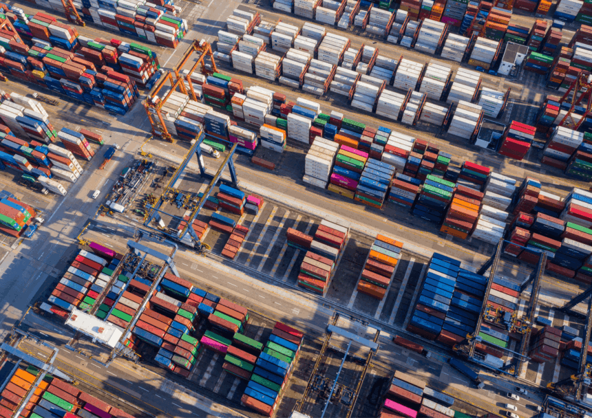 Aerial view of a busy shipping container terminal with rows of colorful containers.