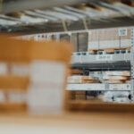 Cardboard boxes stacked on metal warehouse storage shelves.