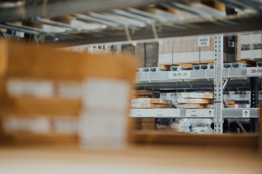 Cardboard boxes stacked on metal warehouse storage shelves.