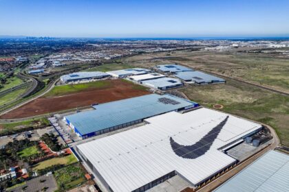 Aerial view of a Nike warehouse complex featuring a large swoosh logo on the roof.