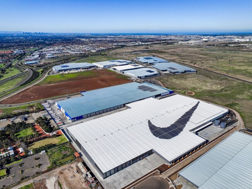 Aerial view of a Nike warehouse complex featuring a large swoosh logo on the roof.