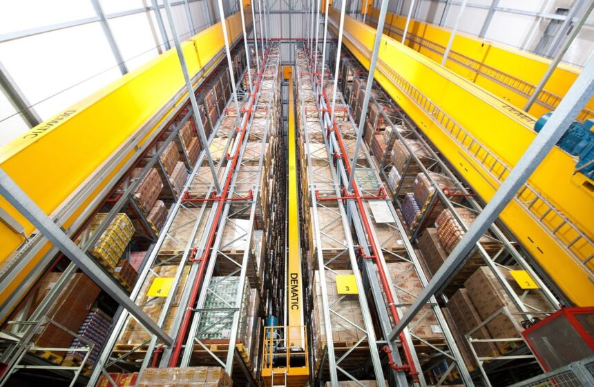 High-angle view of a modern automated warehouse with tall, organized storage racks.