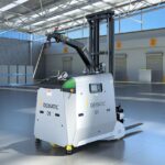A Dematic automated forklift vehicle in a bright, modern warehouse setting.