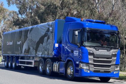 A blue Scania truck with a Colorbond-branded trailer parked on a road.