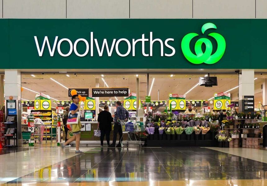 Entrance to a Woolworths supermarket store with customers shopping inside.