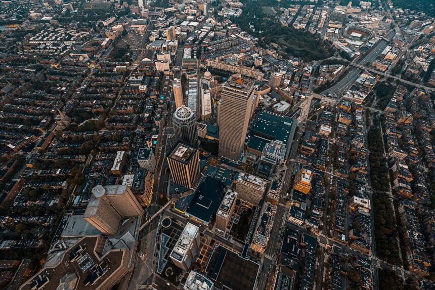 Aerial view of skyscrapers and dense city streets in Boston at twilight.