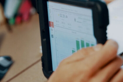 Close-up of a tablet showing manufacturing performance data and charts, representing Argon & Co’s partnership with QAD Redzone.