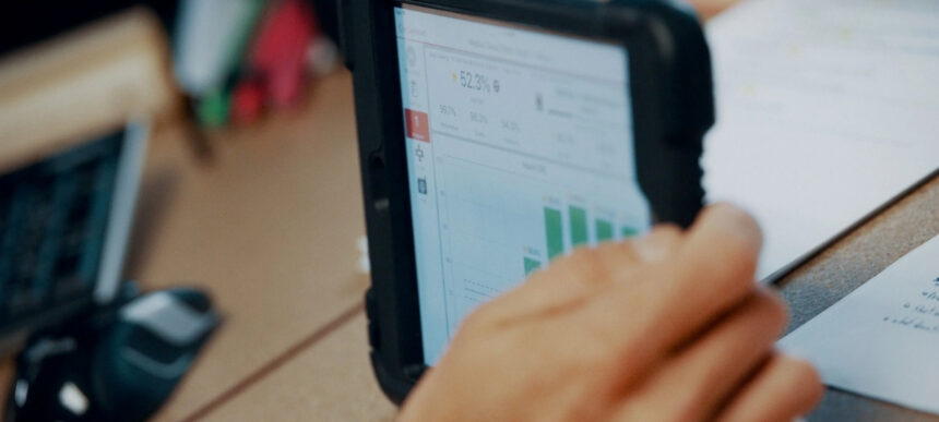 Close-up of a tablet showing manufacturing performance data and charts, representing Argon & Co’s partnership with QAD Redzone.