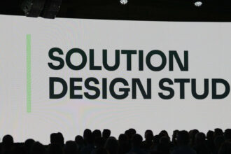 Manhattan Associates presentation introducing Solution Design Studio, an AI-powered supply chain configuration workspace, at a conference event.