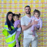 COCO HIT founders standing in front of stacked product cartons, supporting the announcement of the Melbourne startup’s new partnerships.