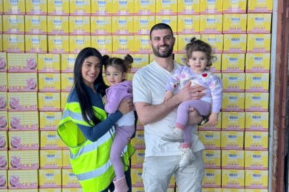 COCO HIT founders standing in front of stacked product cartons, supporting the announcement of the Melbourne startup’s new partnerships.